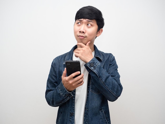 Camisa de jeans de hombre joven con pensamiento de gesto de teléfono inteligente