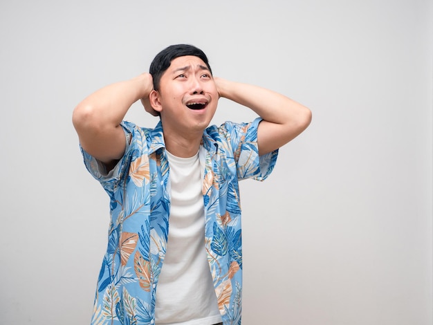 La camisa de la playa del hombre joven sostiene la cabeza y se siente feliz con la reserva de viajes