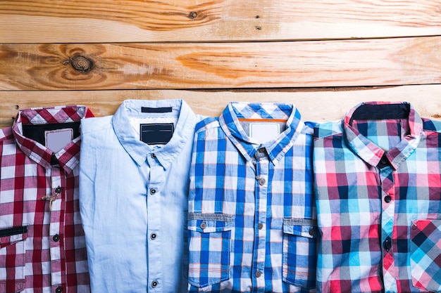 Foto camisas plaid en plano con fondo de madera.