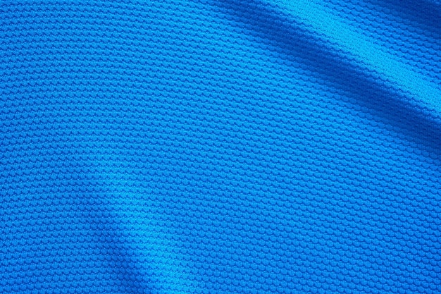 Camiseta de fútbol azul ropa textura de tela ropa deportiva fondo primer plano vista superior