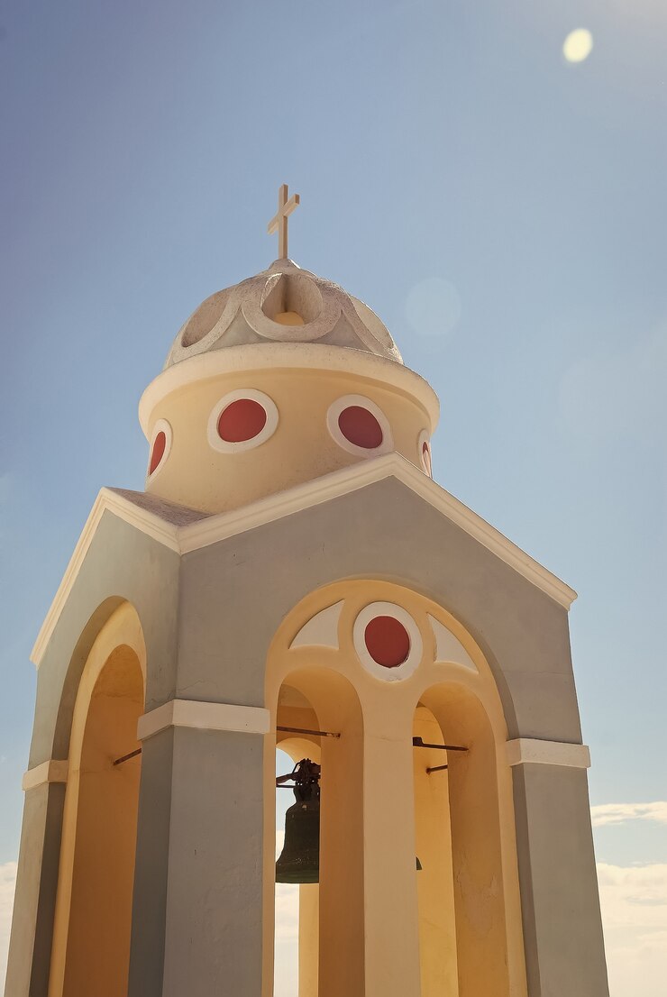 Foto campanario de una iglesia al atardecer, imerovigli village, isla de santorini, grecia