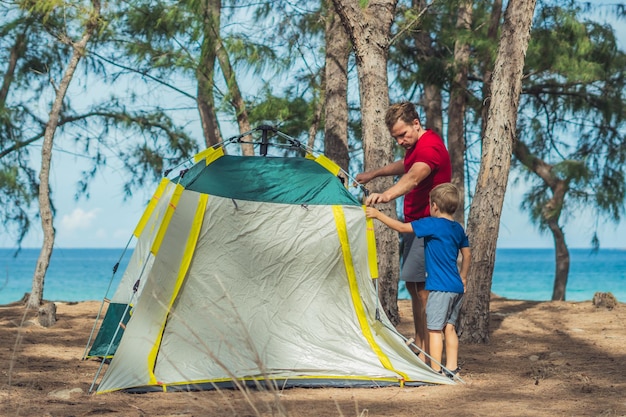 Camping Menschen Outdoor-Lifestyle-Touristen aufgestellt grün grau Campingplatz Sommer Wald in der Nähe von Lazur Sea Junge Sohn hilft Vater Studienmechanismus des modernen einfach zu faltenden Zeltes Natürliche Kindererziehung