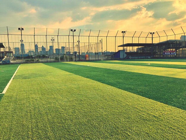 Foto campo de fútbol contra el cielo durante la puesta de sol
