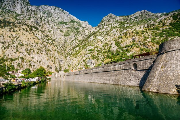 Foto canal fluvial e muralhas da cidade da fortaleza da cidade velha de kotor montenegro