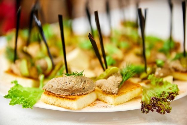 Canapé com patê de frango torrado branco frito e pepino em conserva