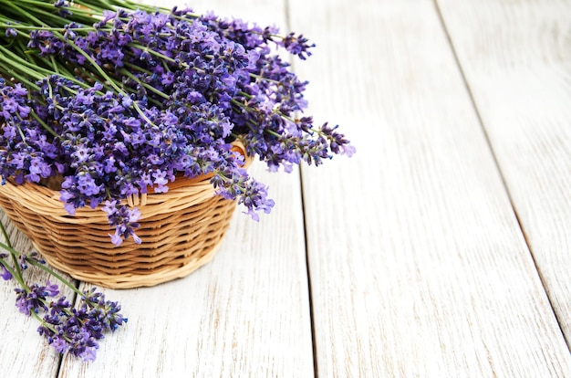 Foto una canasta con flores de lavanda en una vieja mesa de madera