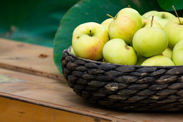 Una canasta con manzanas amarillas en el mercado.