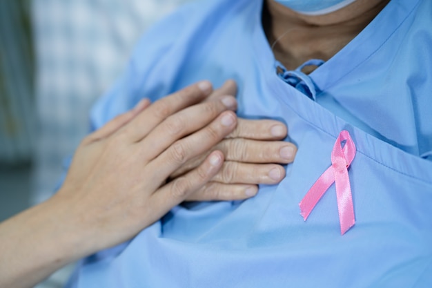 Câncer de mama, fita rosa para paciente idosa asiática para apoiar a conscientização.