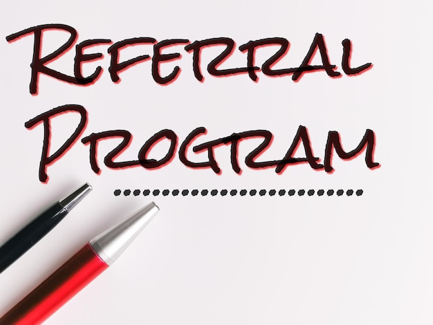 Canetas isoladas em fundo branco com texto REFERRAL PROGRAM.