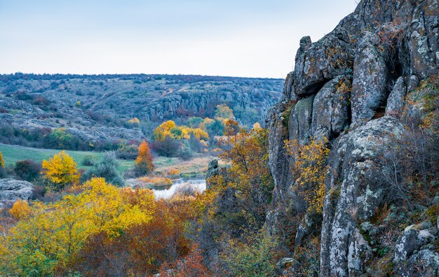 Cañón de Aktovsky, Ucrania. Árboles otoñales y grandes cantos rodados de piedra alrededor