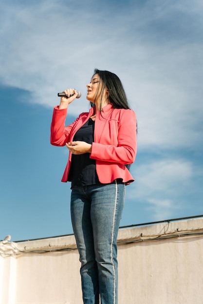 cantante pop cantando con un micrófono en el techo