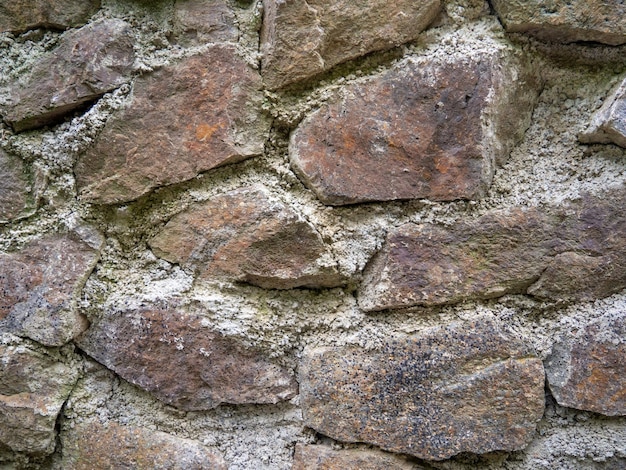 Cantaria antiga As pedras são reforçadas com argamassa antiga Parede antiga de alvenaria irregular