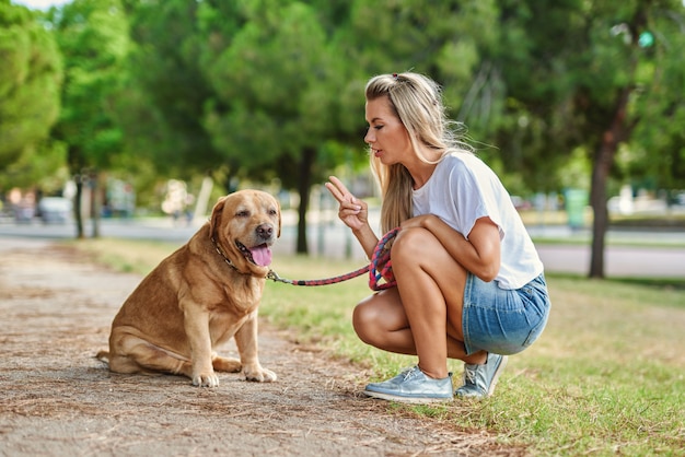 Cão de treinamento de mulher no parque.