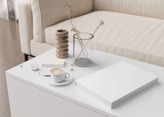 Capa de livro branco simulada com vaso de xícara de café e outros acessórios domésticos na mesa branca Modelo em branco para seu projeto Apresentação de capa de livro ou catálogo renderização em 3D