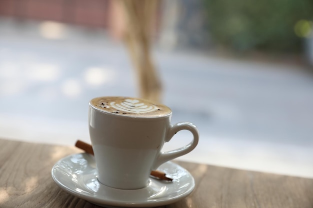 Cappuccino oder Latte Art Kaffee aus Milch auf dem Holztisch im Café