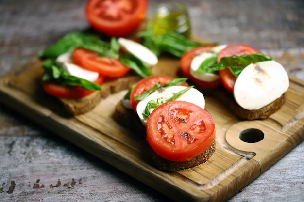 Caprese-Toast auf einem Holzbrett