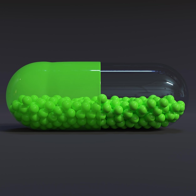 Cápsula verde transparente com grânulos com fundo escuro