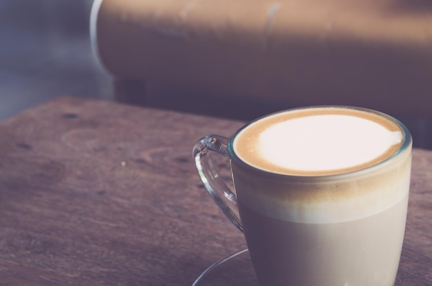 Capuchino en taza en una mesa de madera