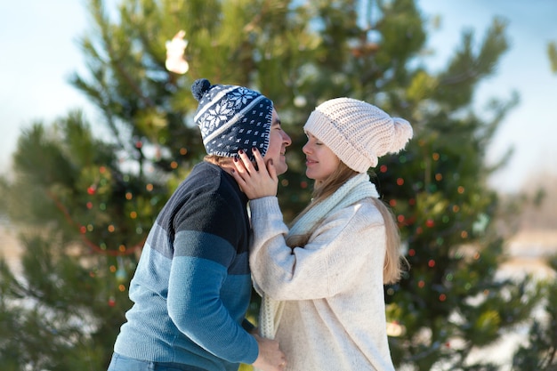 Cara com um beijo de garota no inverno na floresta.