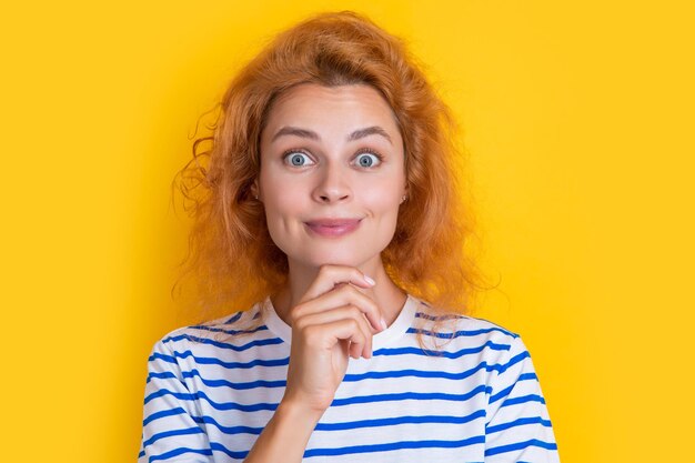 Cara de ruiva espantada isolada no rosto de fundo amarelo de uma jovem ruiva no estúdio