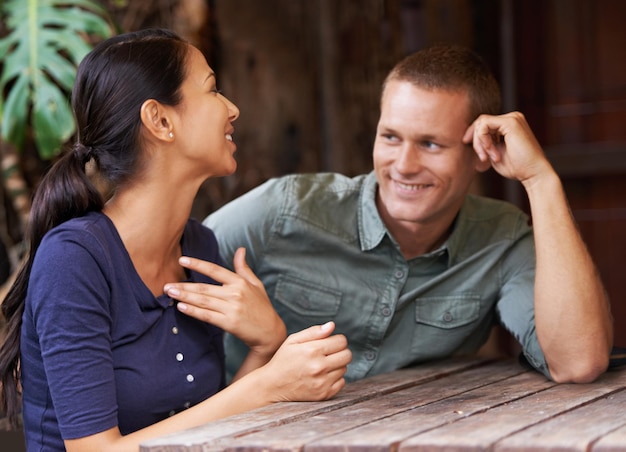 Cara, eu adoro ficar em dia com todas as fofocas femininas Um jovem casal conversando enquanto está sentado em um café