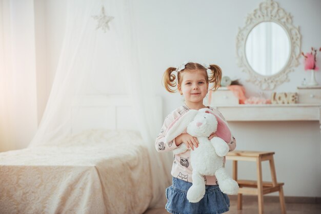 Cara feliz menina engraçada. Em uma sala iluminada