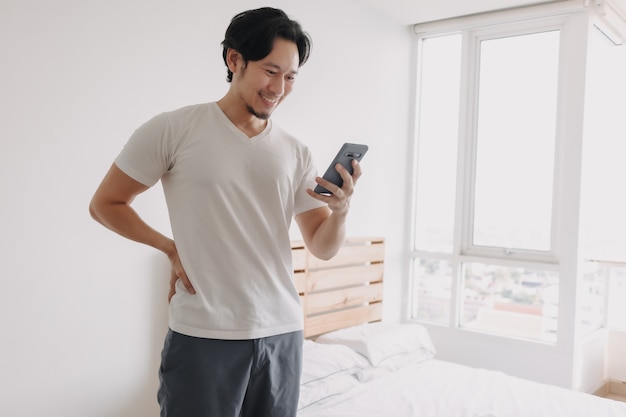 Cara feliz y sonriente del hombre con smartphone