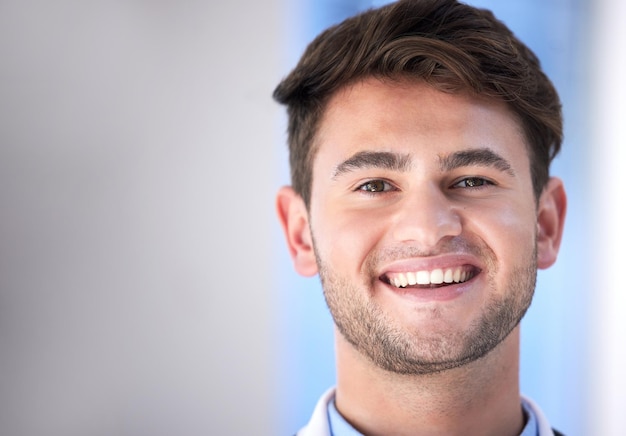 Cara de hombre y sonrisa en retrato con médico profesional de la salud y tiro en la cabeza con espacio de maqueta Feliz en medicina con atención médica de cardiocirujano joven masculino y médico en el hospital de Londres