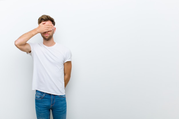 cara jovem, cobrindo os olhos com uma mão