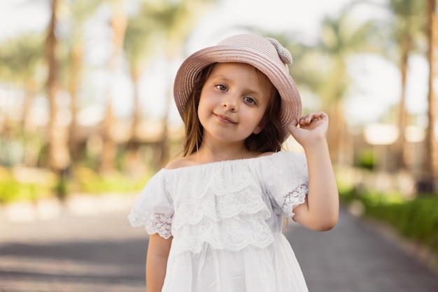 La cara de una niña en el fondo de las palmeras.