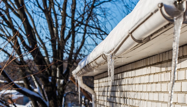 carámbanos de hielo en los tejados de las casas