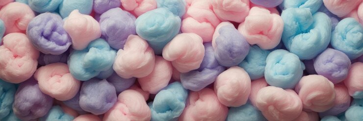 Foto caramelo de algodón azul rosado y púrpura en un fondo de color pastel suave