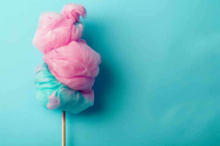 Foto caramelo de algodón multicolor en un palo sobre un fondo azul