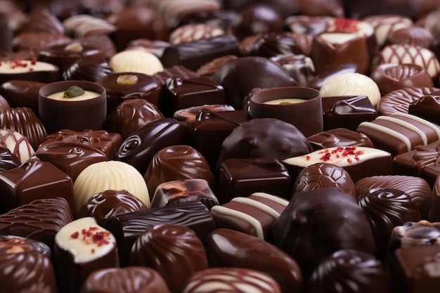 Caramelos de chocolate con varios rellenos, pared de alimentos dulces.