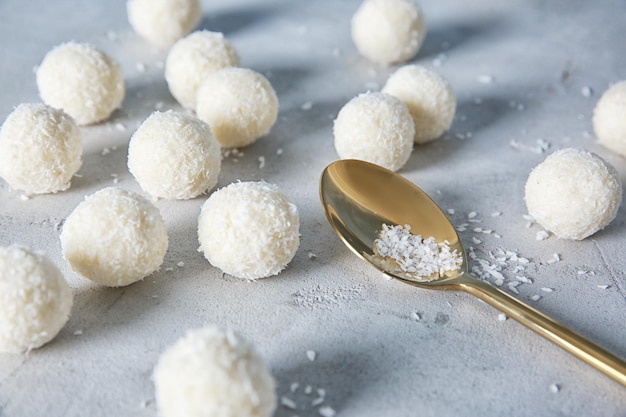 Caramelos de coco y cuchara en la mesa