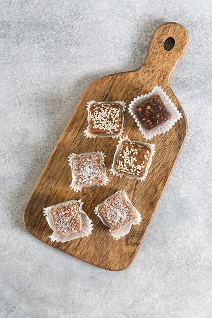 Caramelos dulces veganos saludables hechos a mano en la tabla de cortar de madera