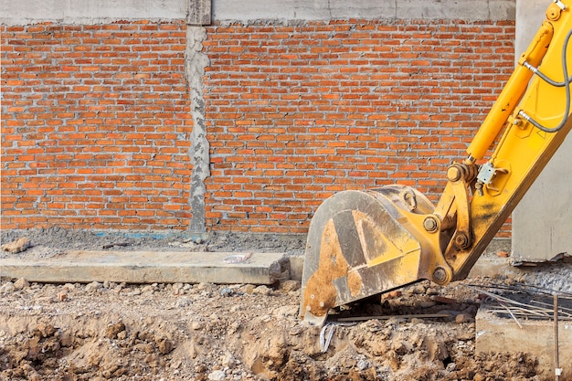 Foto cargador de excavadora o retroexcavadora en un sitio de construcción con enfoque suave en el fondo. ove