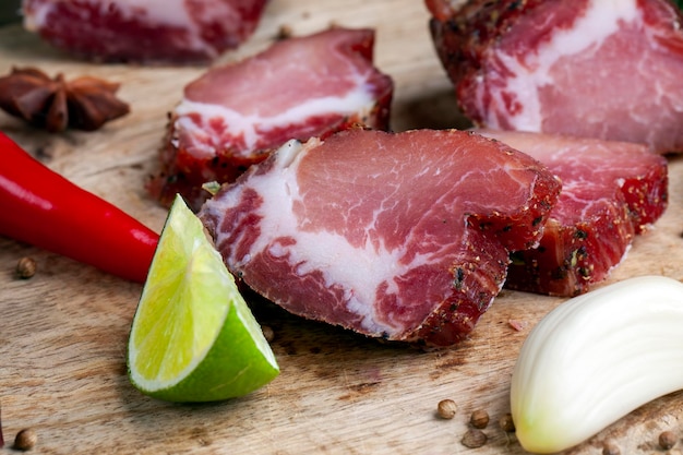 Carne de cerdo y tocino en rodajas durante la cocción