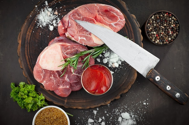 Carne crua com especiarias em uma composição com acessórios de cozinha