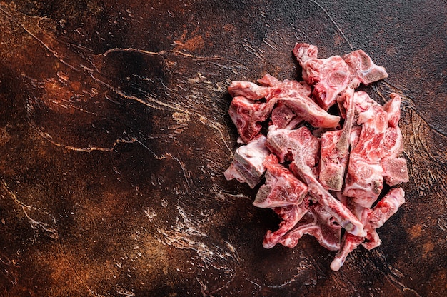 Foto carne crua com osso cortada em cubos para guisado. vista do topo.