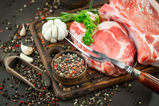 Carne cruda con especias en una composición con accesorios de cocina