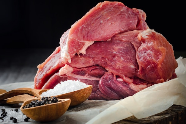 Carne cruda, sal y pimienta sobre un fondo negro