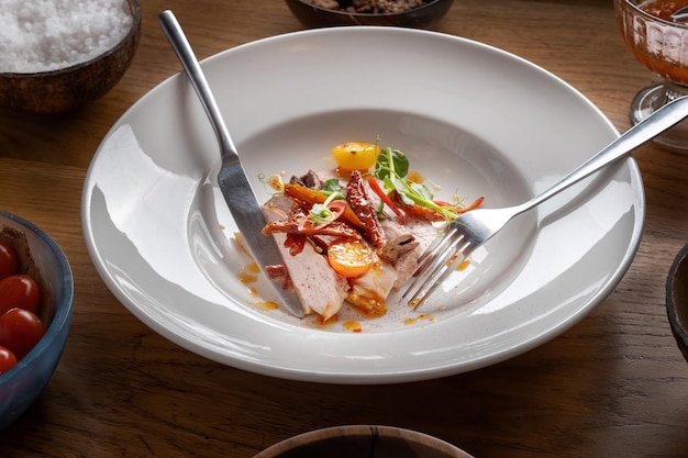 Carne de pato assada com tomates brotos verdes pequenos e molho decorado com tomates secos