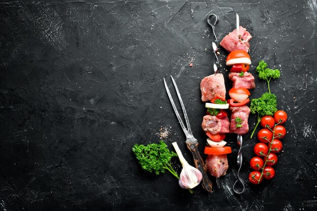 Carne de porco crua shish kebab Carne de churrasco com legumes e especiarias Vista superior Espaço livre para o seu texto Estilo rústico
