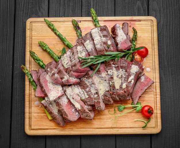 Carne de res en rodajas sobre tabla de madera