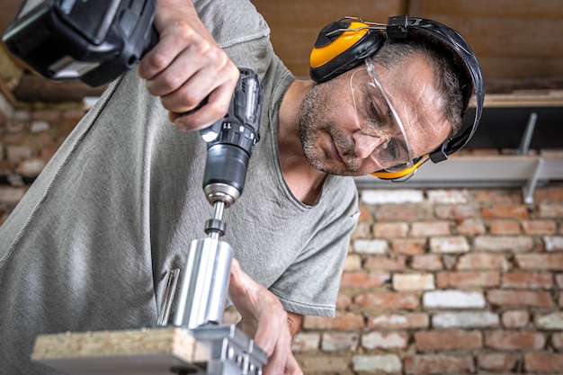 Carpintero profesional que trabaja con madera y herramientas de construcción en casa.