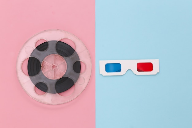 Carretel de filme e óculos 3D anáglifo em azul rosa. Indústria do entretenimento. Cinema