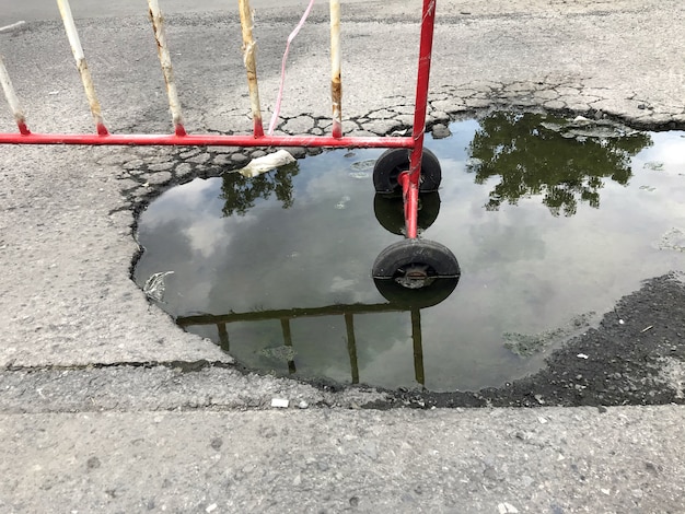 Carretera de asfalto rota con agua, sin zona de paso