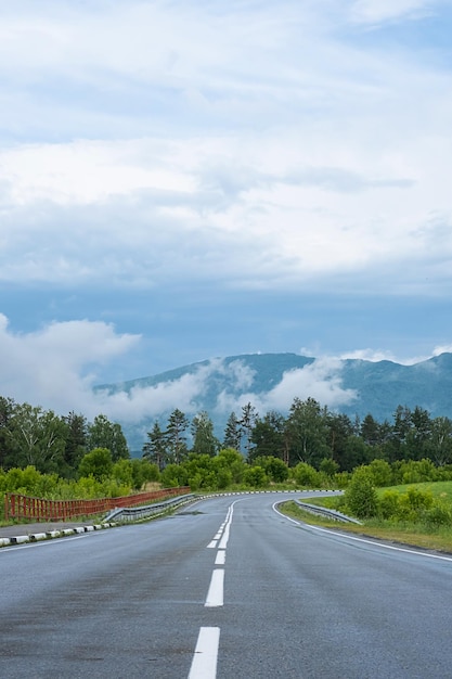 Carretera vacía Speedway sin coches en montañas en medio de bosques de pinos Aventura o fondo de viaje por carretera