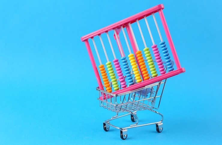 Foto carrinho de compras com ábaco em um fundo azul